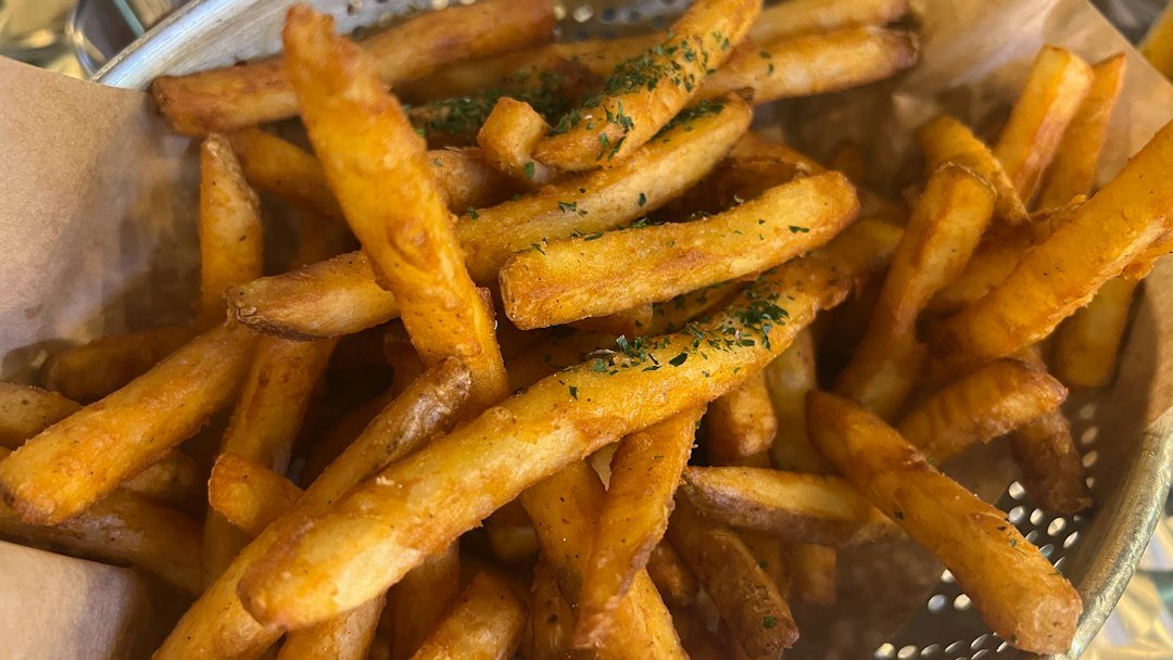 Basket of crispy seasoned french fries