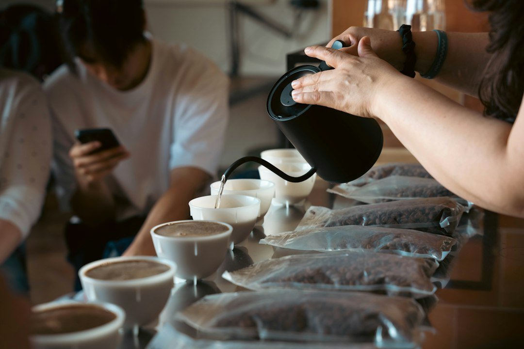 Barista pouring water into a cup for coffee