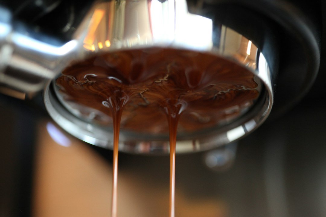 Espresso pouring from a coffee machine portafilter