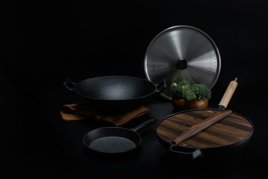 brown wooden handled stainless steel cooking pan