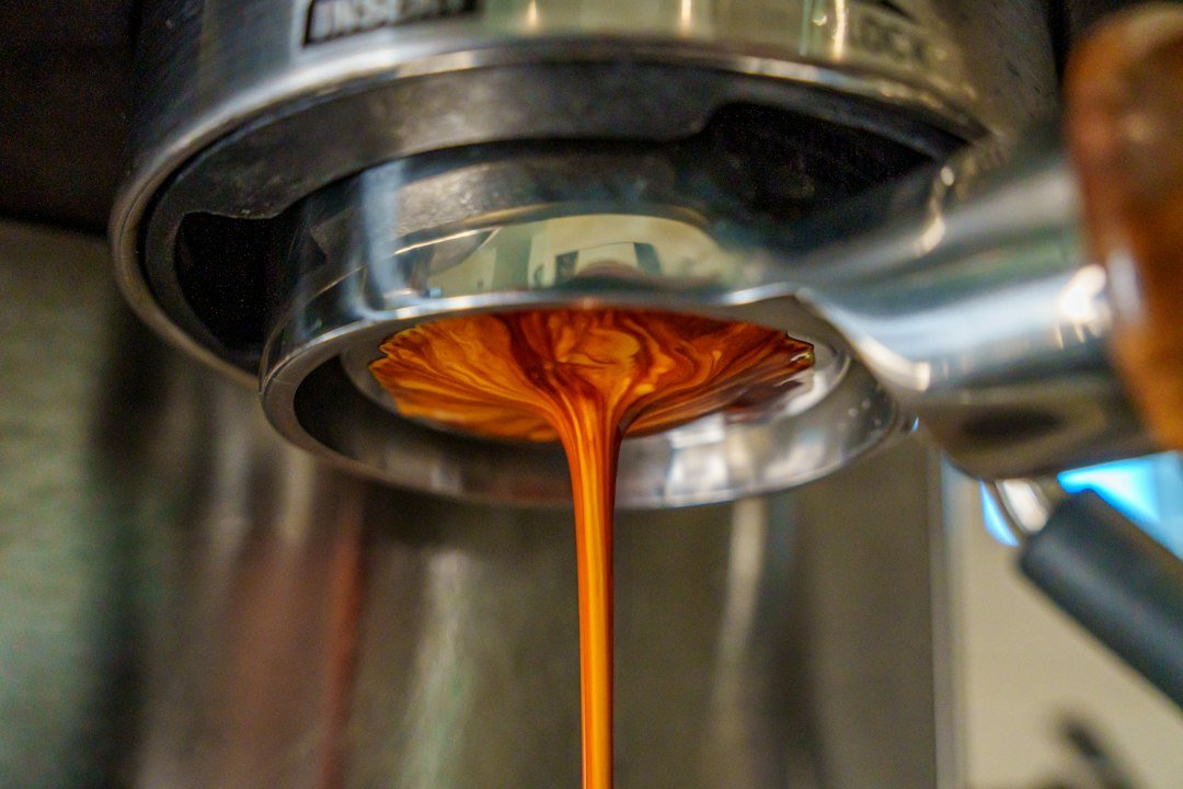 Espresso coffee being extracted from a machine portafilter