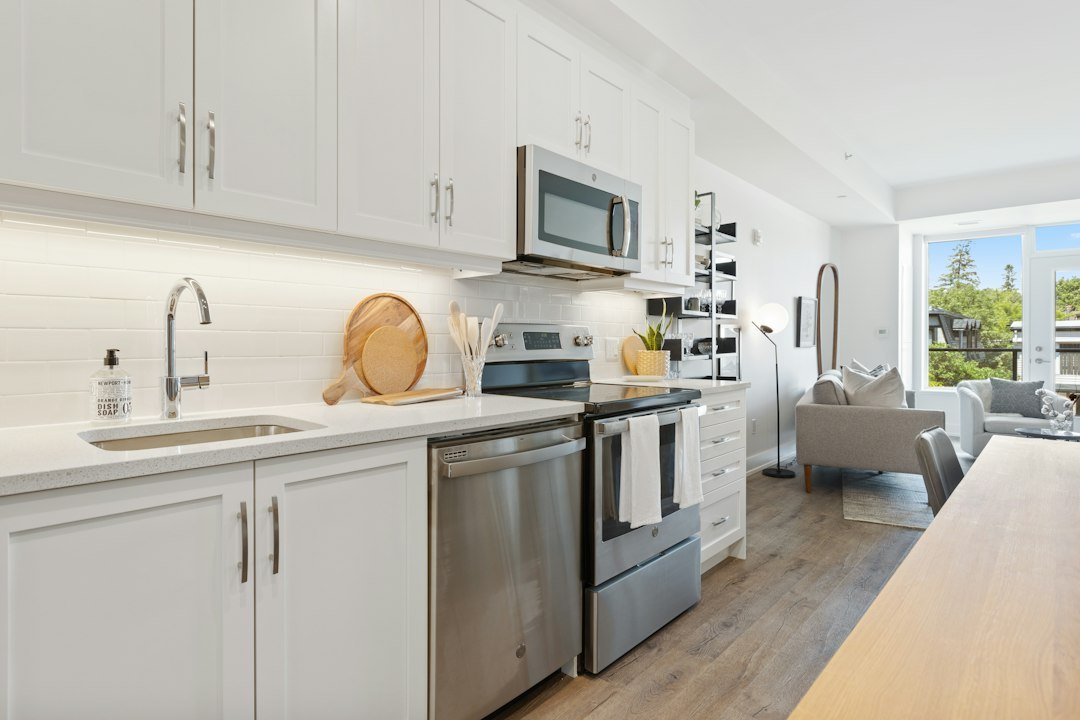 white microwave oven on white wooden kitchen cabinet