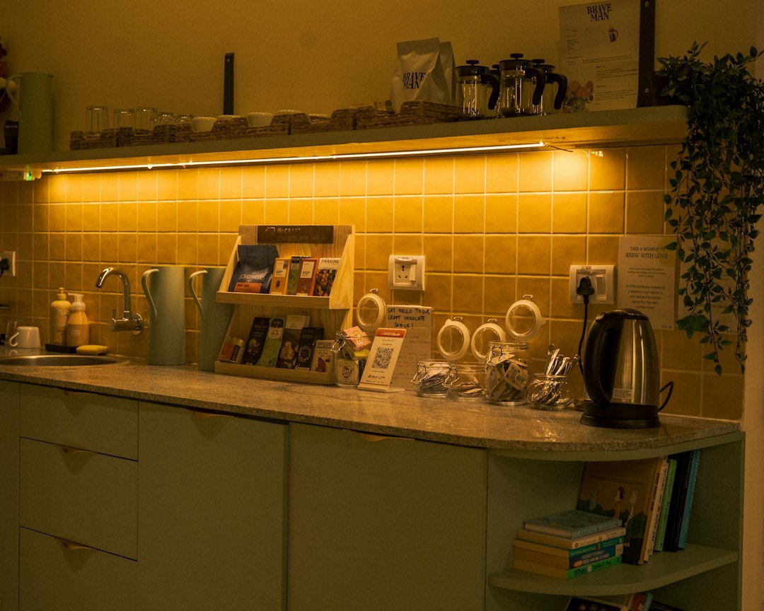 A kitchen counter with tea supplies and kettle